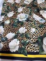 Floral and cheetah pattern fabric featuring white roses and green leaves on a cheetah print background with black and yellow border