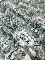 Green and white wild forest animal print fabric with detailed nature-inspired design for sewing and home decor projects