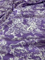 Purple fabric with white wild forest animal pattern for upholstery and crafts