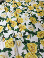 Yellow floral rose pattern fabric with green leaves on white background for crafts and home decor