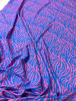 Blue and pink zebra pattern fabric with vibrant exotic animal print and 150cm width