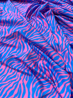 Blue and pink zebra pattern fabric with vibrant exotic animal print and smooth texture