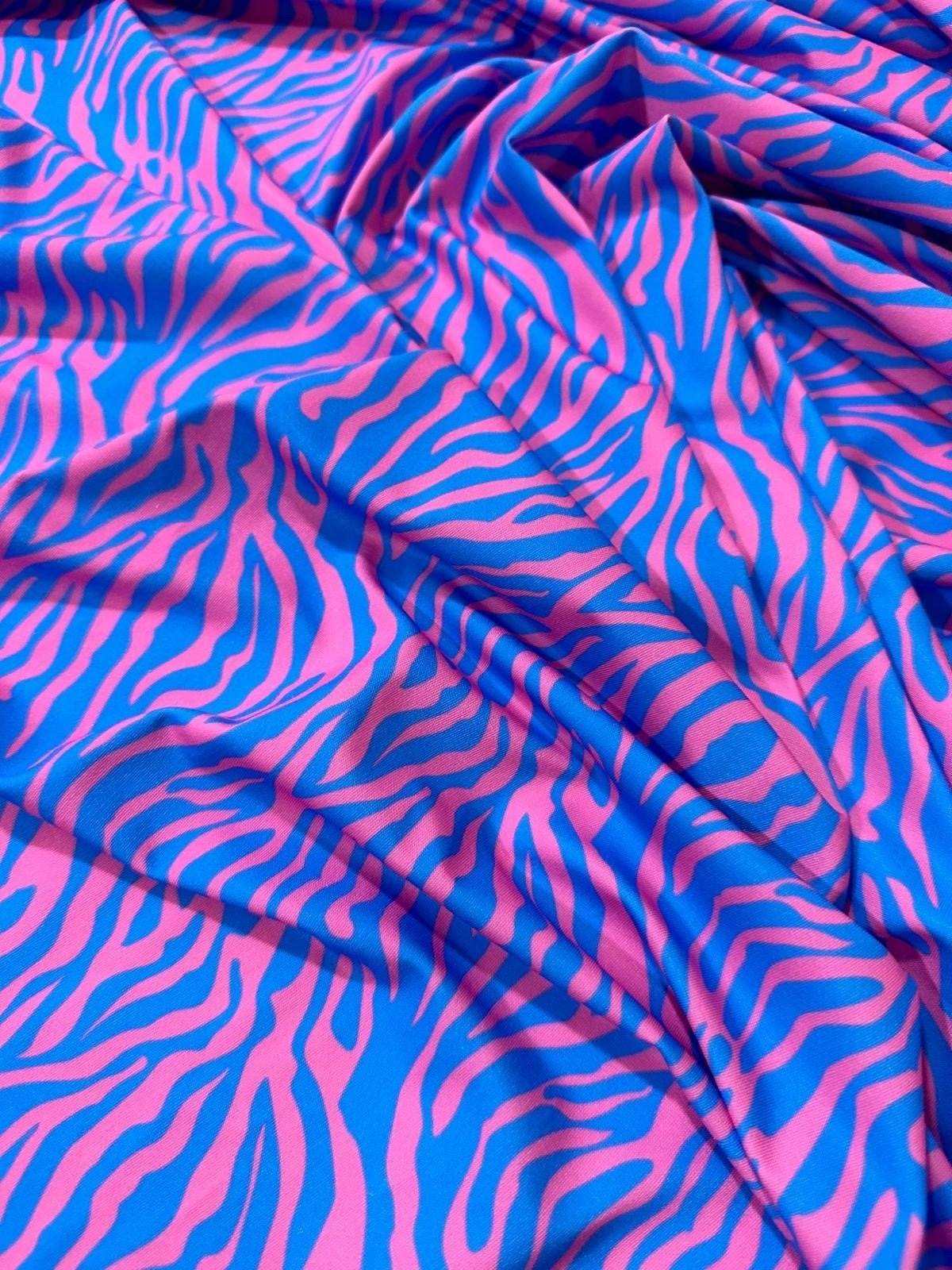 Blue and pink zebra pattern fabric with vibrant exotic animal print and smooth texture