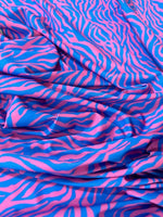 Blue and pink zebra pattern fabric with vibrant animal print, 150cm wide, ideal for fashion and crafts