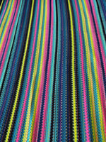 Colorful zigzag knit jersey fabric with vibrant stripes in pink, yellow, blue, and black for versatile fashion projects