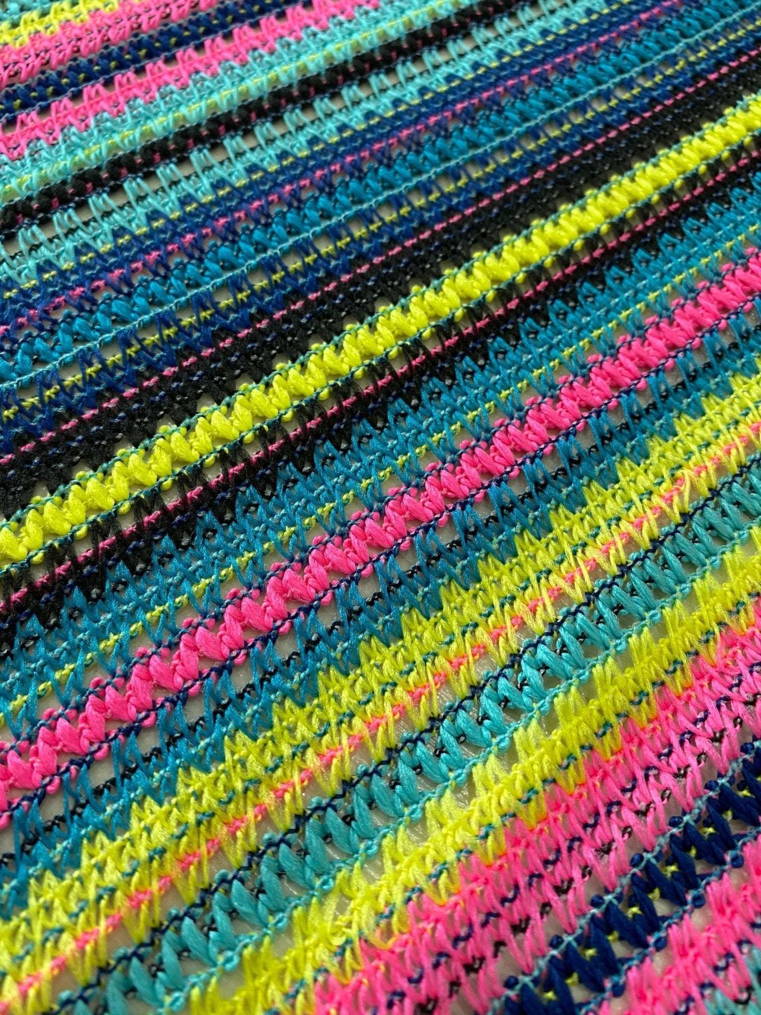 colorful zigzag knit jersey fabric texture with bright blue, pink, yellow, and black stripes