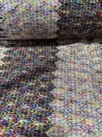 Black and white zigzag knit jersey fabric with colorful multicolor chevron pattern and soft texture