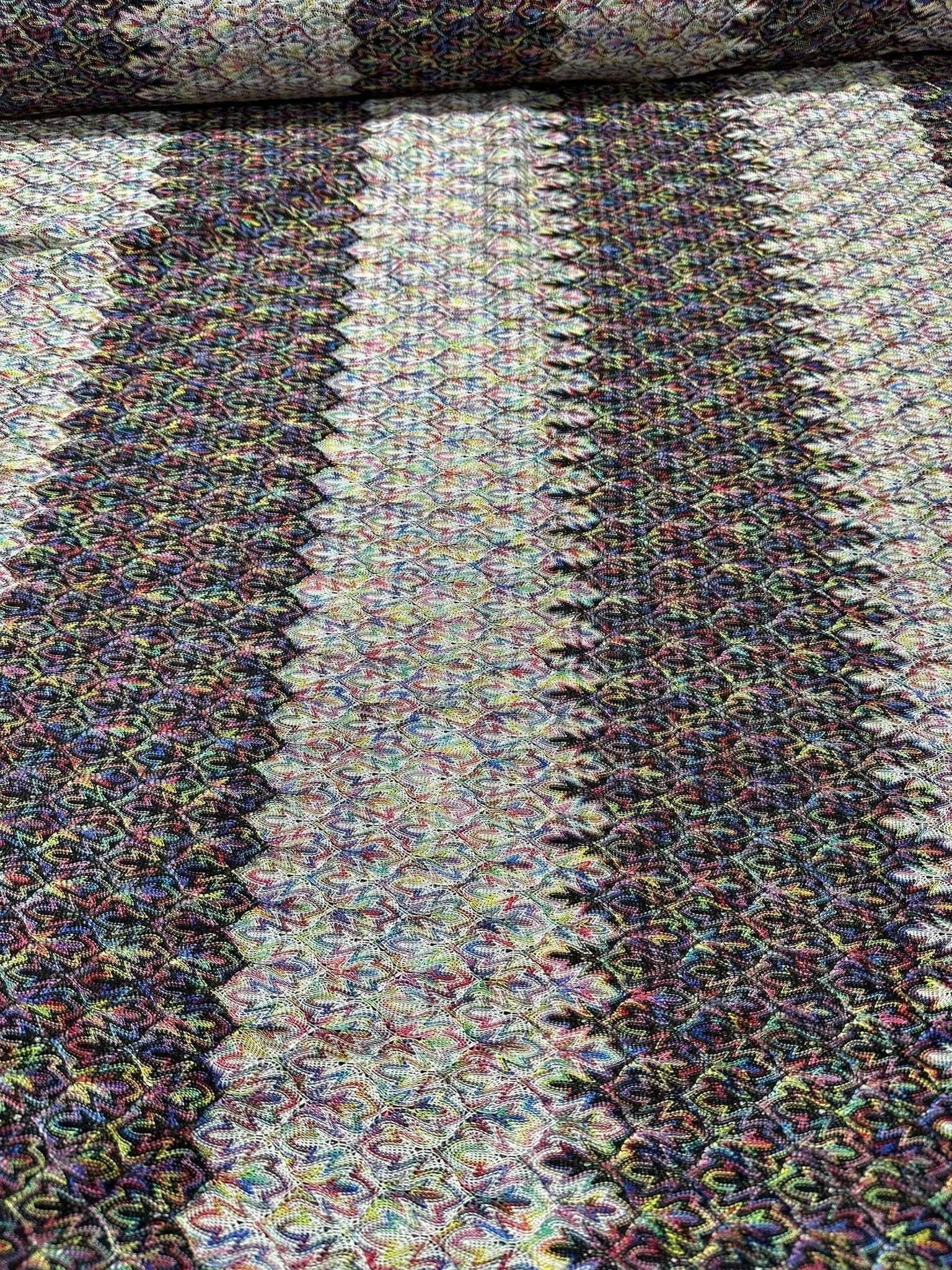 Black and white zigzag knit jersey fabric with colorful accents and chevron pattern