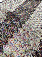 Black and white zigzag knit jersey fabric with colorful pattern details and soft texture