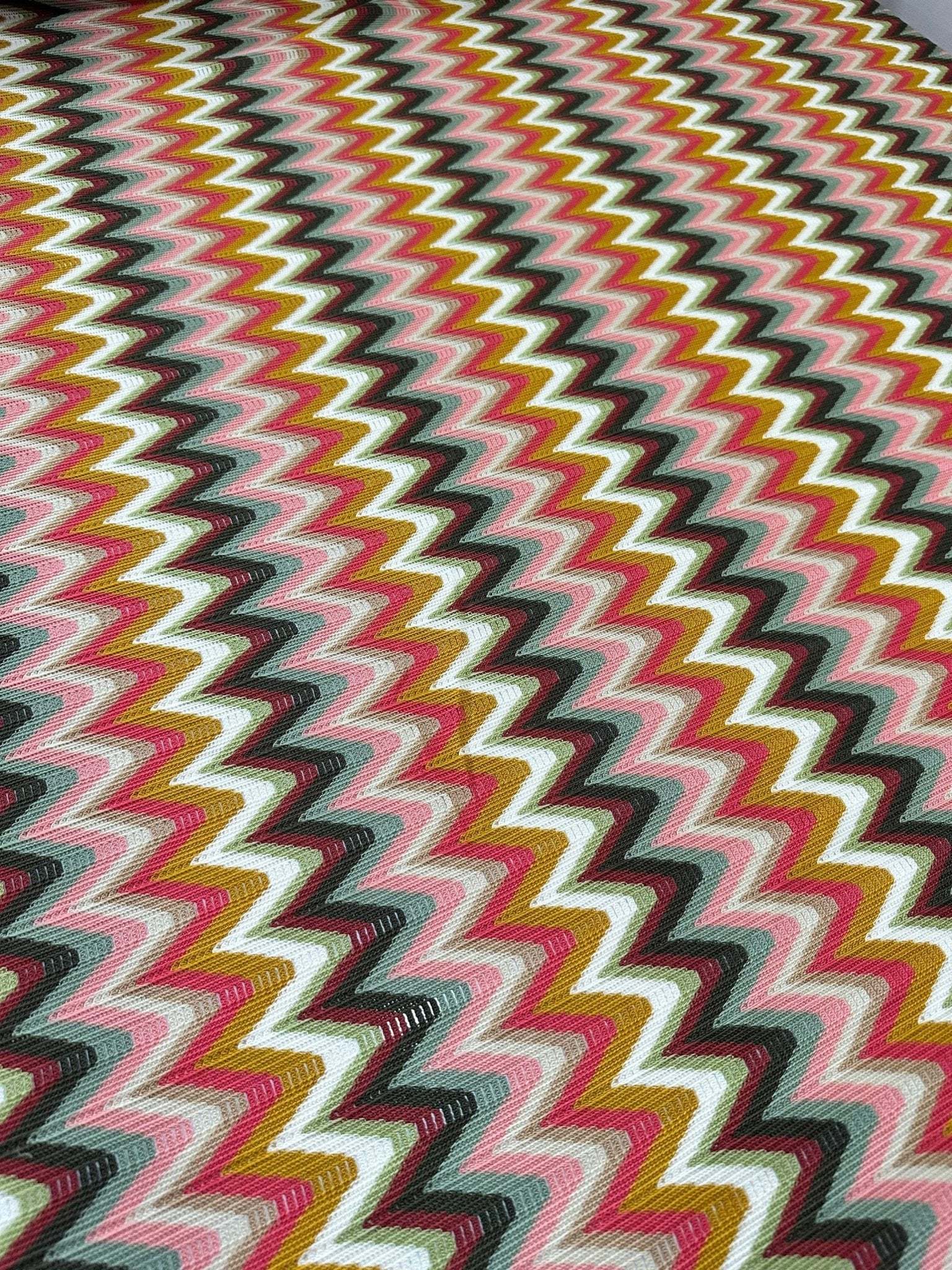 Luxury autumn chevron zigzag knit jersey fabric in pink, mustard, white, and black colors with wide 150cm width.