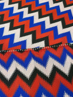 Luxury zigzag knit jersey fabric with vibrant blue, red, black, and pink zigzag pattern, perfect for elegant garments