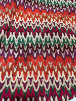 Multicolor zigzag knit jersey fabric with chevron pattern and vibrant colors, perfect for elegant clothing projects