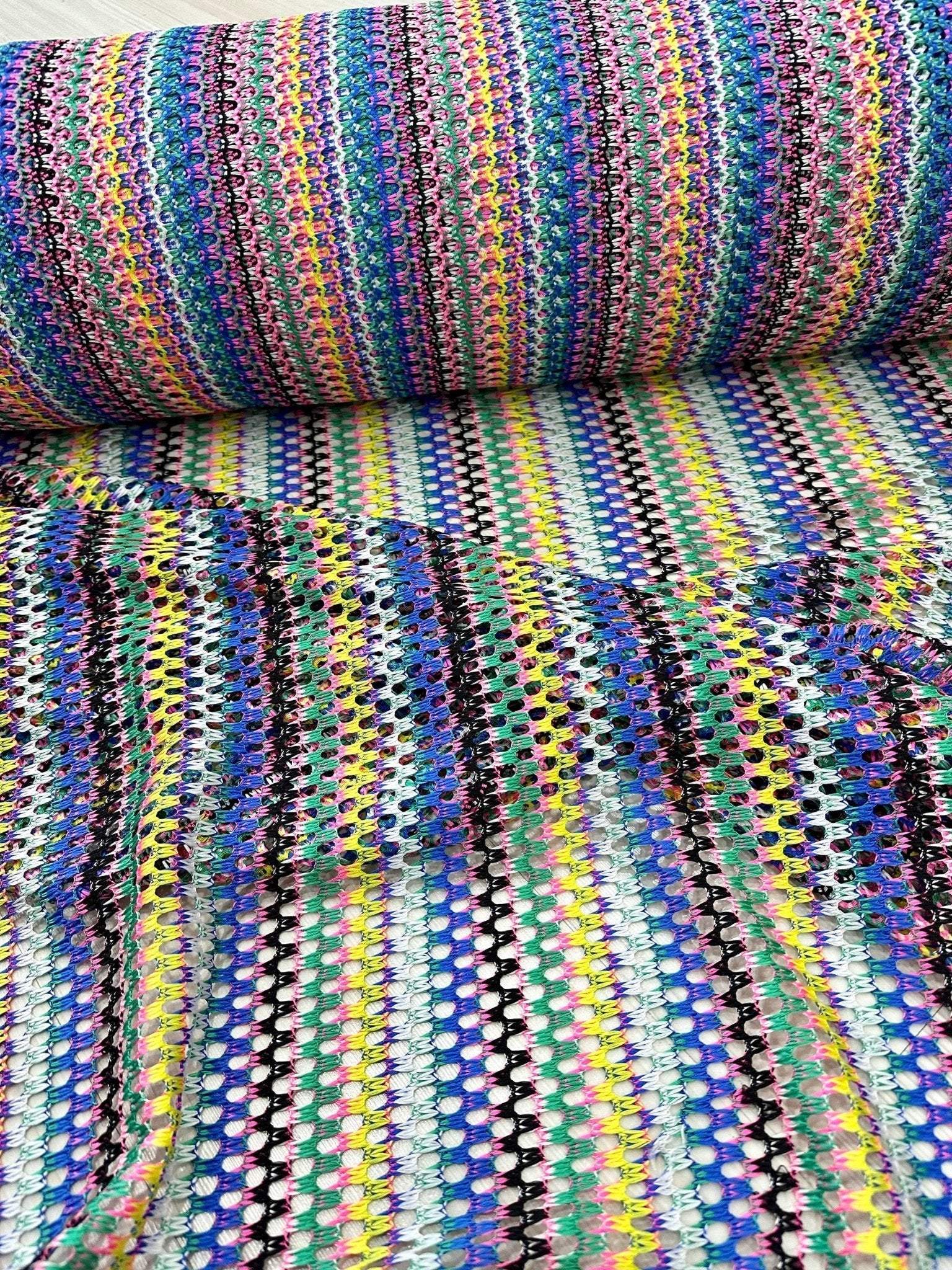 Multicolor chevron zigzag knit jersey fabric with vibrant multicolor striped pattern ideal for clothing and sewing projects.