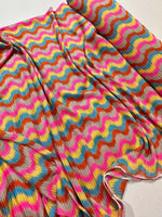 Luxury zigzag knit jersey fabric with pink and blue chevron design, soft and stretchy for sewing projects