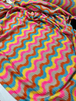 luxury zigzag knit jersey fabric with pink and blue chevron pattern draped smoothly