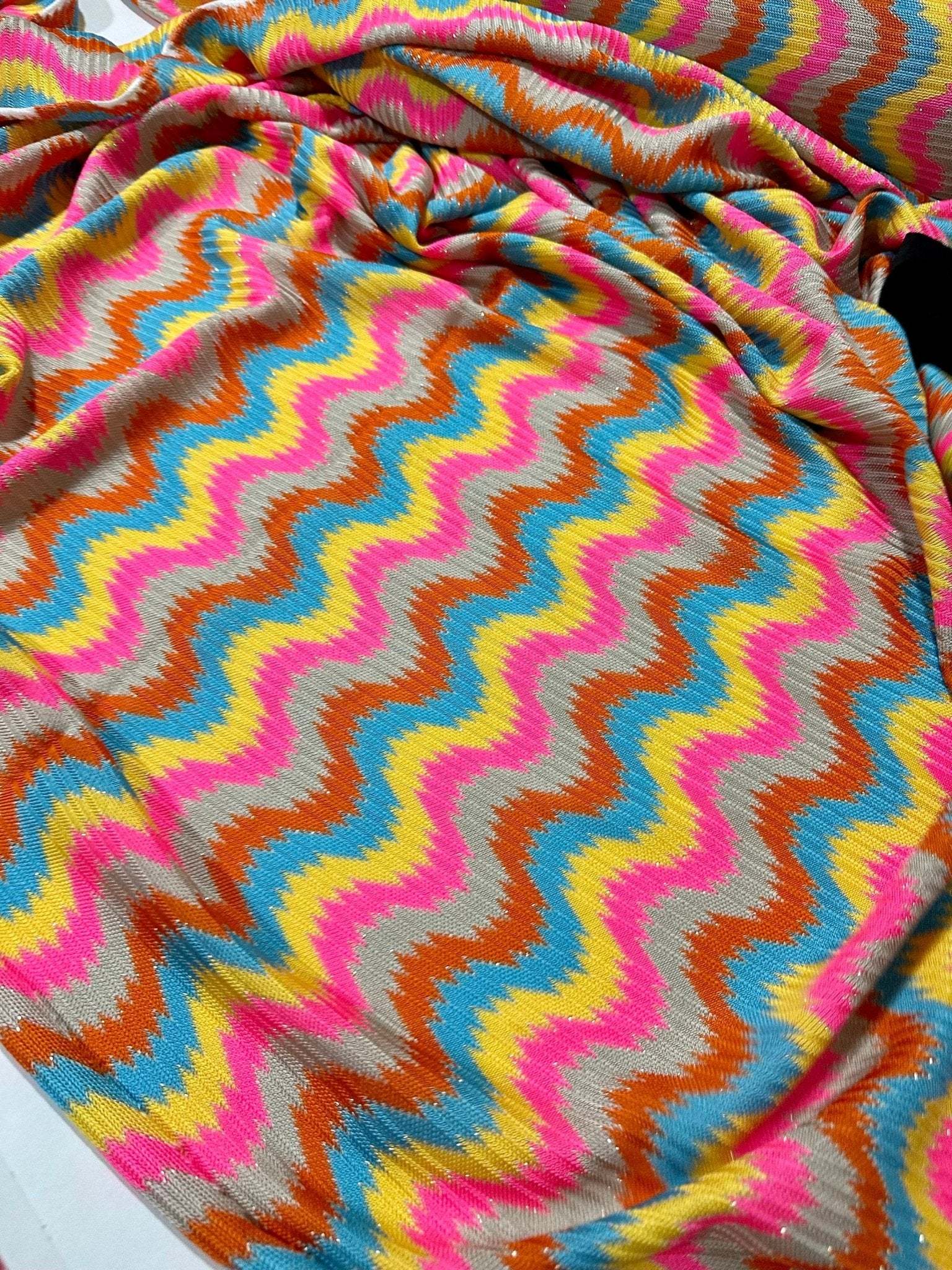 luxury zigzag knit jersey fabric with pink and blue chevron pattern draped smoothly