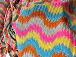 Luxury zigzag knit fabric with vibrant pink, blue, yellow, orange, and gray chevron pattern for stylish clothing projects
