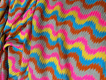 Luxury zigzag knit jersey fabric with pink, blue, yellow, and orange chevron pattern
