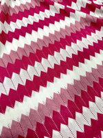 Luxury zigzag knit jersey fabric in pink and white with chevron pattern and soft texture
