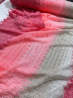 Pink and white chevron zigzag knit jersey fabric with textured pattern and soft feel, ideal for sewing garments