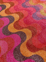 Close-up of shimmer spandex fabric with multicolor zigzag pattern suitable for evening dresses and activewear