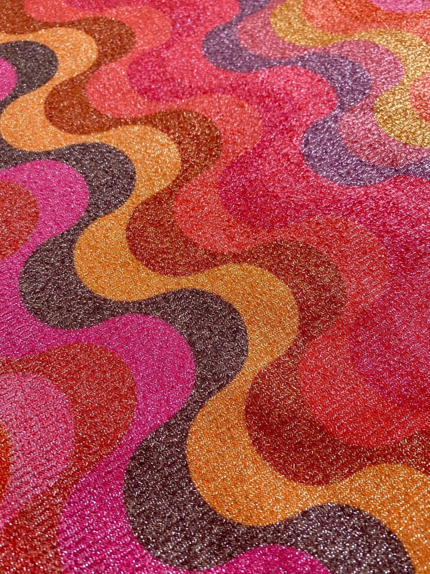 Close-up of shimmer spandex fabric with multicolor zigzag pattern suitable for evening dresses and activewear