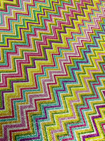 Multicolor shimmer zigzag knit fabric with gold Lurex finish and vibrant polyester texture